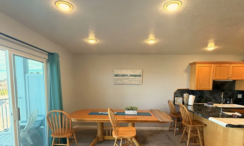Open dining area and kitchen with sliding doors to a private deck